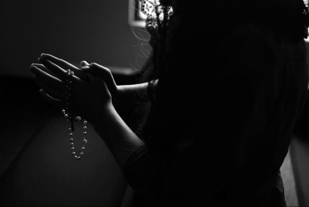 lady holding rosary beads