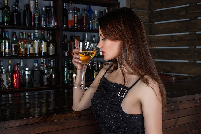 woman drinking cocktail