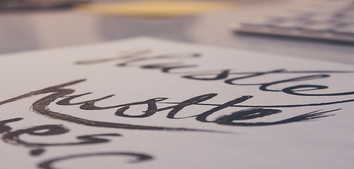 hustle written in caligraphy